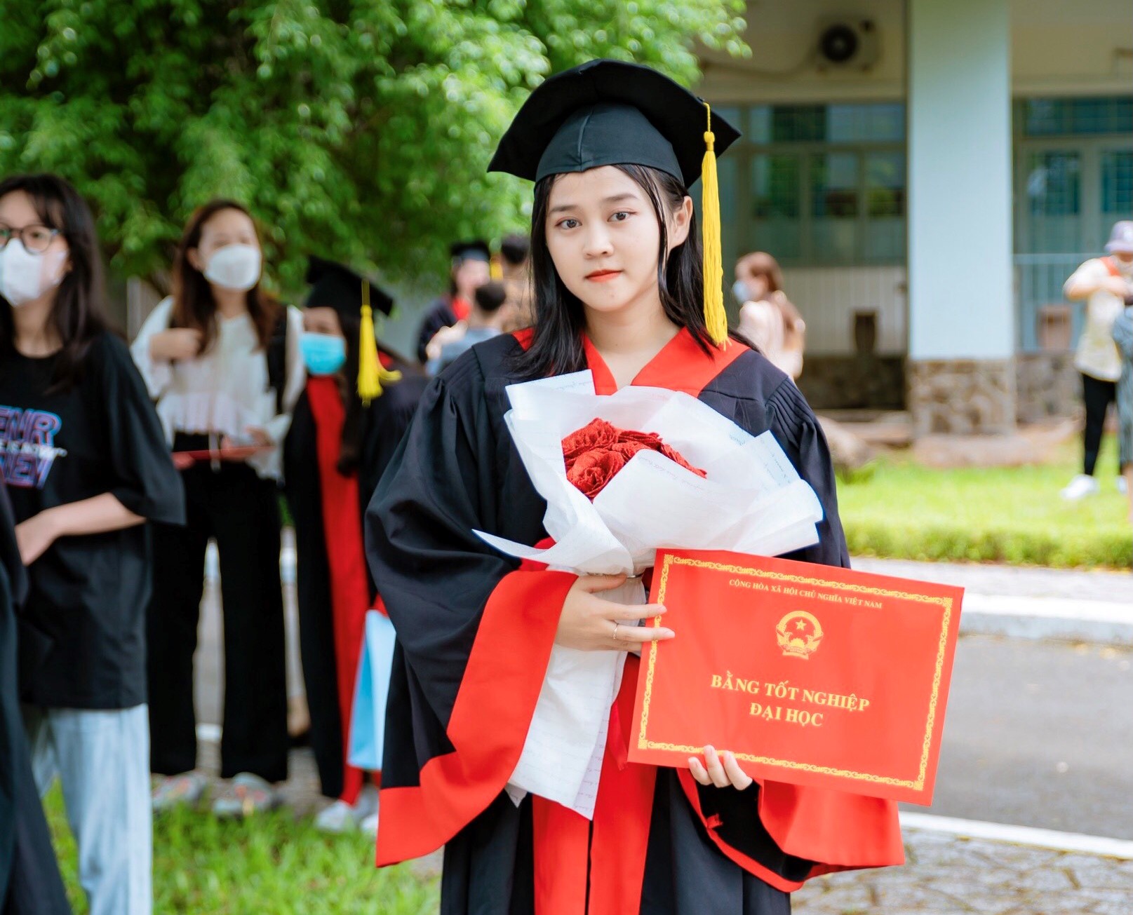 Chụp ảnh với áo cử nhân và hoa tươi